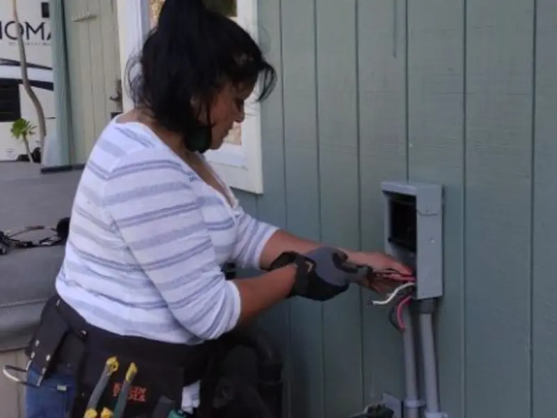 Licensed electrician wiring an exterior subpanel in Parker
